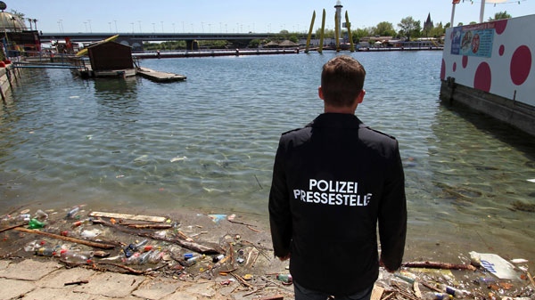 Police spokesman Roman Hahslinger looks at an area in the Danube river where the body of Libyan former oil chief Shukri Ghanem was found drowned in Vienna, Austria, Monday, April 30, 2012. (AP  / Ronald Zak)