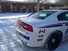 A London police cruiser sits outside B. Davison Secondary School, after a gun call, in London, Ont. on Friday, Jan. 9, 2015. (Colleen MacDonald / CTV London)