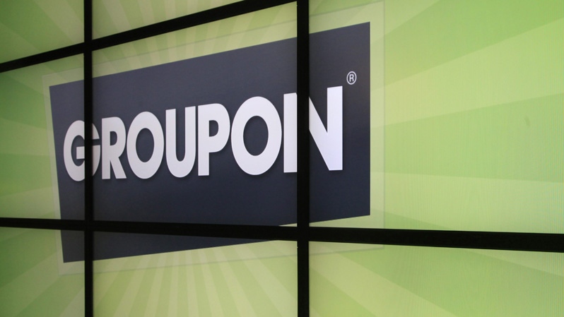 In thisfile photo, the Groupon logo is displayed inside the online coupon company's offices, in Chicago. (AP Photo/Charles Rex Arbogast, File)