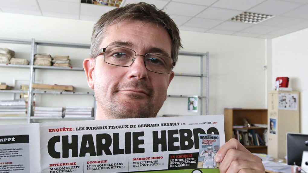 Stephane Charbonnier with a copy of Charlie Hebdo