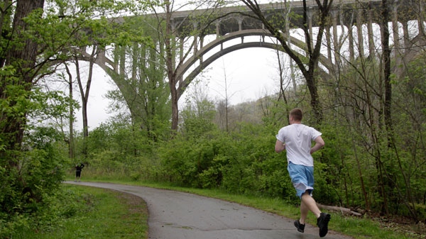 A jogger runs along the tow path approaching a bridge at the Cuyahoga Valley National Park in Brecksville, Ohio, on Tuesday, May 1, 2012. (AP / Amy Sancetta)