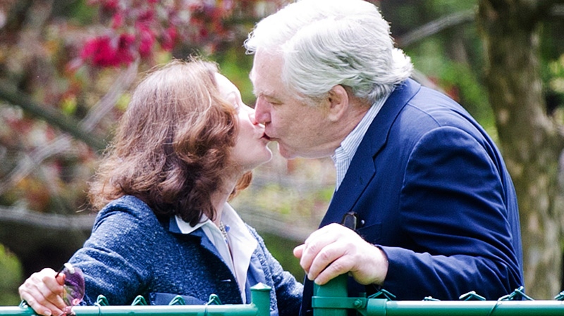 Conrad Black, right, kisses his wife Barbra Amiel Black as he arrives at his Bridle Path residence in Toronto on Friday, May 4, 2012. . (Nathan Denette / THE CANADIAN PRESS)