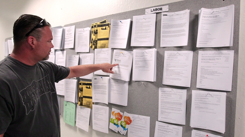 Tom Holloway looks for work at a sign board at JobTrain, an employment center, in Menlo Park, Calif., on Friday, April 20, 2012. (AP / Paul Sakuma)