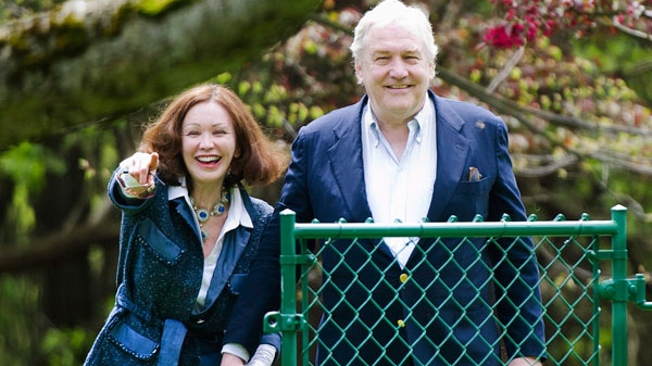 Conrad Black and his wife Barbra Amiel Black watch their two dogs as he arrives at his Bridle Path residence in Toronto on Friday, May 4, 2012. (Nathan Denette / THE CANADIAN PRESS)