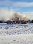 Crews battle a fire at a barn containing a large number of pigs in Southwest Middlesex, Ont. on Friday, Jan. 16, 2015. (Celine Moreau / CTV London)