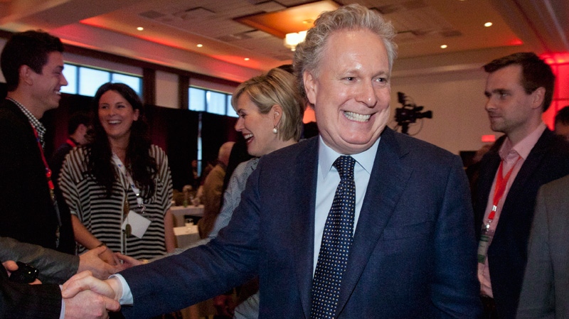 Quebec Premier Jean Charest shakes hands with delegates in a hotel where the Quebec Liberal Party is meeting in Victoriaville, Que., Saturday, May 5, 2012. (Jacques Boissinot / THE CANADIAN PRESS)