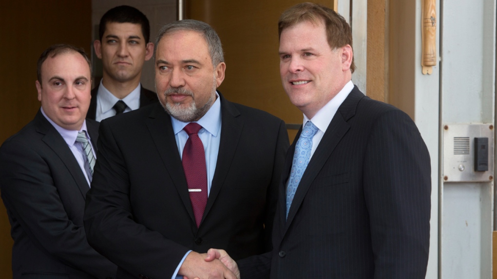 Avigdor Lieberman shakes hands with John Baird