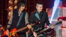 Nikki Sixx, left, and DJ Ashba of Sixx:A.M. perform on stage at the iHeart Theatre in Los Angeles, on Tuesday Oct. 7, 2014. (Paul A. Hebert / Invision)