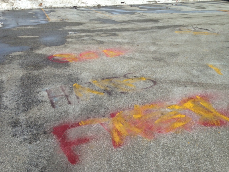 Covered-up hate messaging can be seen in the parking lot at St. Anne Catholic High School in Lakeshore, Jan.23, 2015. (Chris Campbell / CTV Windsor)