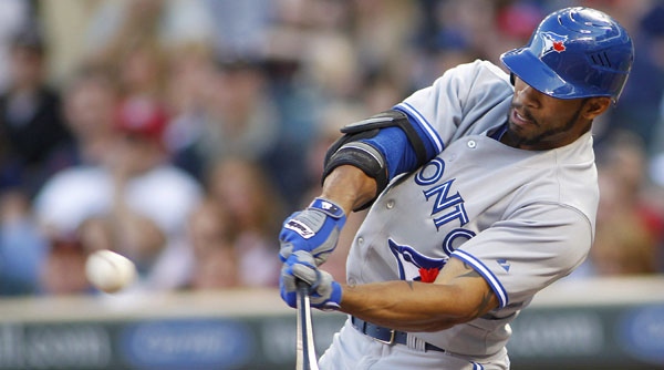 Toronto Blue Jays Eric Thames hits an RBI sacrifice fly ball in the first inning against the Minnesota Twins during a baseball game in Minneapolis on Thursday, May 10, 2012. (AP Photo/Andy King)