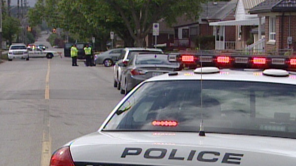 Police investigate after a woman was struck by a vehicle pulling out of a driveway in Guelph, Ont. on Wednesday, May 9, 2012. 
