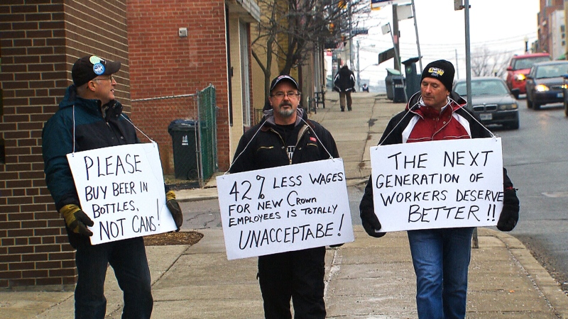 Workers demonstrate against Crown Holdings outside a Toronto Beer Store on Saturday, Jan. 24, 2015.
