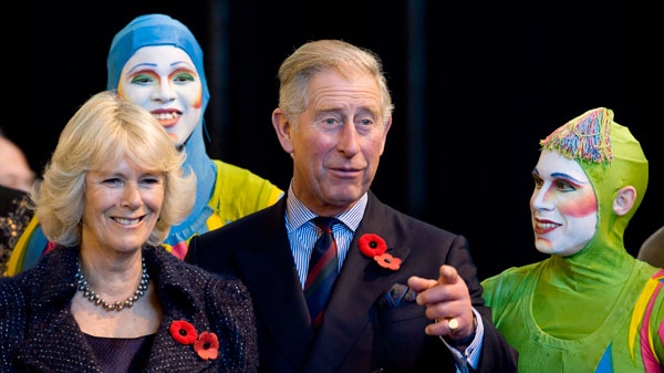 Prince Charles gestures while chatting with performers at the Cirque du Soleil headquarters in Montreal as Camilla, the Duchess of Cornwall, looks on, Tuesday, Nov., 10, 2009. (Graham Hughes / THE CANADIAN PRESS)