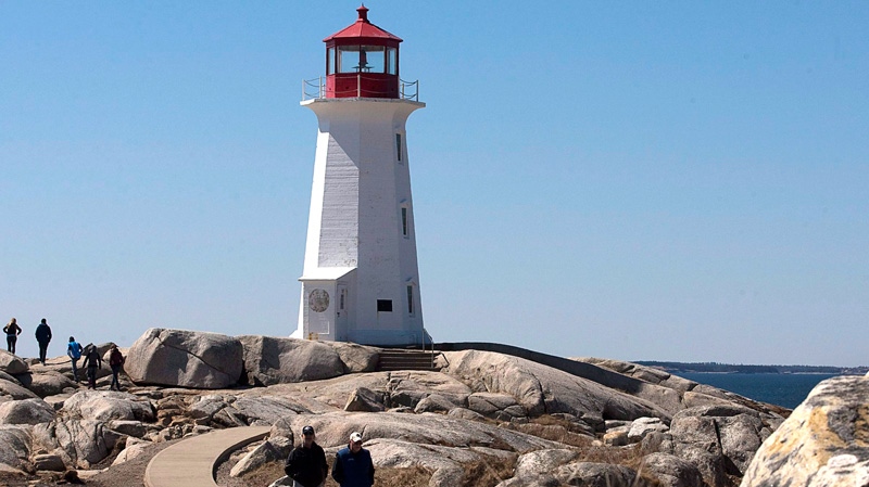 Tourists visit the lighthouse at Peggy's Cove, N.S. on Friday, April 8, 2011. (Andrew Vaughan / THE CANADIAN PRESS)