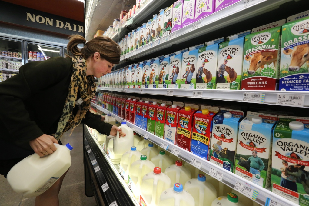 Grocery person stocks dairy products in Denver