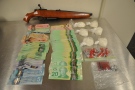 A shotgun, drugs and cash seized from a home on Pond Mills Road are seen in this photo released by the London Police Service on Tuesday, Jan. 27, 2015.