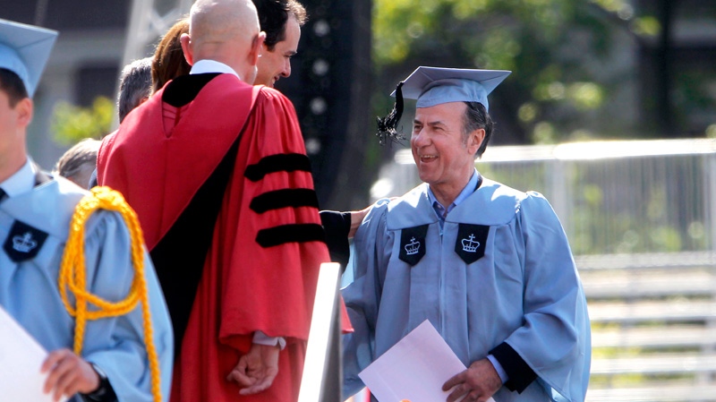 Columbia University janitor Gac Filipaj smiles as he is congratulated during the Columbia University School of General Studies graduation ceremony in New York, Sunday, May 13, 2012. (AP / Jason DeCrow)