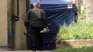 A tent is seen as police investigate after the body of 19-year-old John James was found in Kitchener, Ont. over the weekend, Monday, May 14, 2012.