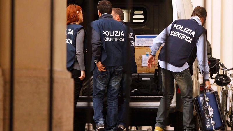 Forensic police unload equipment in the courtyard of Sant' Apollinare Basilica, in Rome