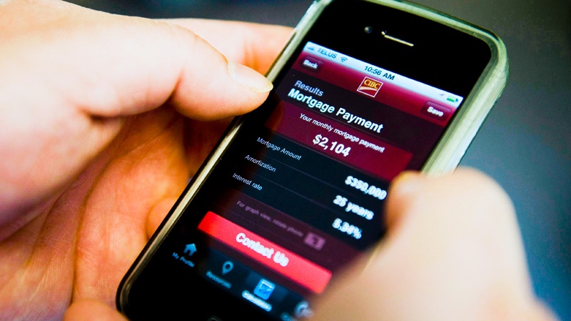 A smart phone user checks their bank account with an online banking app from CIBC in Ottawa on Friday, April 1, 2011. (Sean Kilpatrick / THE CANADIAN PRESS)
