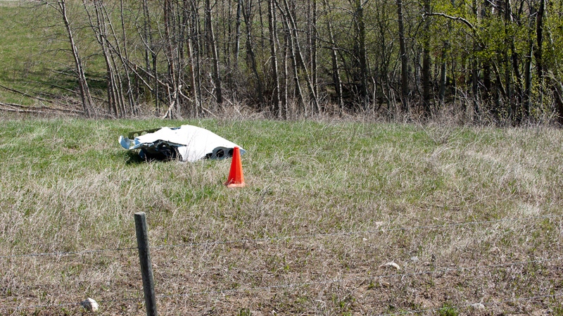 A piece of a plane that was found by a local farmer lies in a field after a mid-air collision near St. Brieux, Sask. Sunday, May 13, 2012. (Liam Richards / THE CANADIAN PRESS)