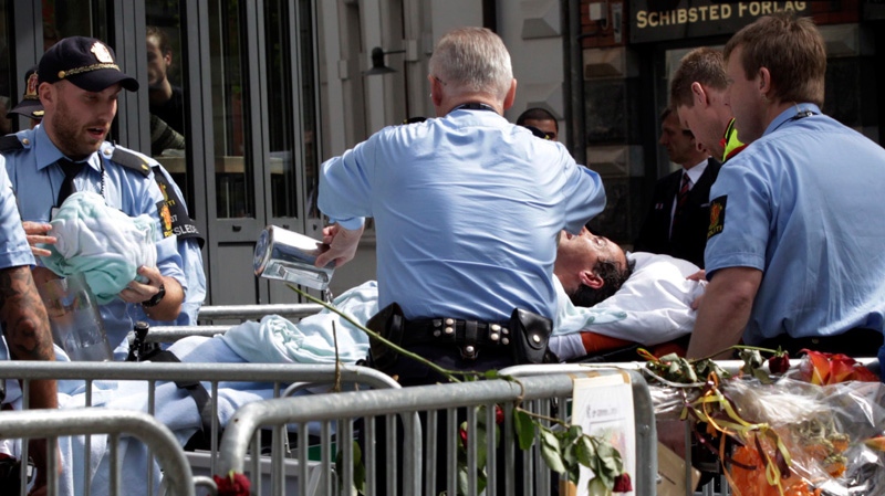 An unidentified man is stretchered to an ambulance after setting fire to himself outside the Oslo, Tuesday, May 15, 2012. (AP / Berit Roald / NTB scanpix)