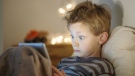 Child with a tablet computer. (Jack Frog / shutterstock.com)
