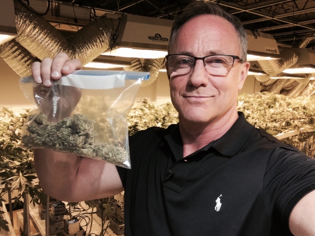 Kevin Newman holds up a bag of marijuana inside a legal dispensary in Denver, Colo. 