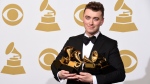Sam Smith poses in the press room with the awards for best new artist, best pop vocal album for “In the Lonely Hour”, song of the year for “Stay With Me”, and record of the year for “Stay With Me” at the 57th annual Grammy Awards at the Staples Center in Los Angeles on Sunday, Feb. 8, 2015. (Chris Pizzello/Invision/AP)