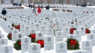 People are shown placing Christmas wreaths on grave stones in Beechwood cemetery during a ceremony for Wreaths Across Canada, honouring military veterans, in Ottawa on Dec. 1, 2013. The Canadian Security Intelligence Service wants to create a national burial site at the cemetery for its employees. (Fred Chartrand / THE CANADIAN PRESS)