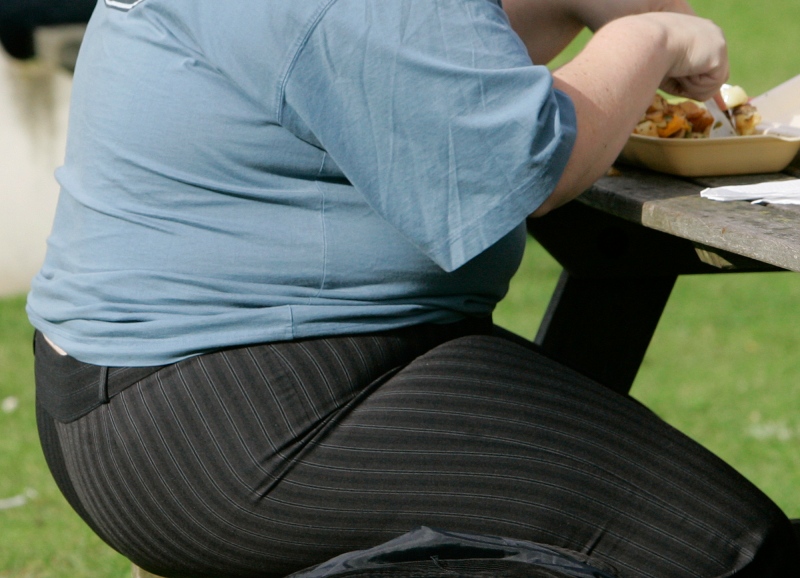 In this Wednesday, Oct. 17, 2007 file photo, an overweight person eats a meal in London. (AP Photo/Kirsty Wigglesworth, File)