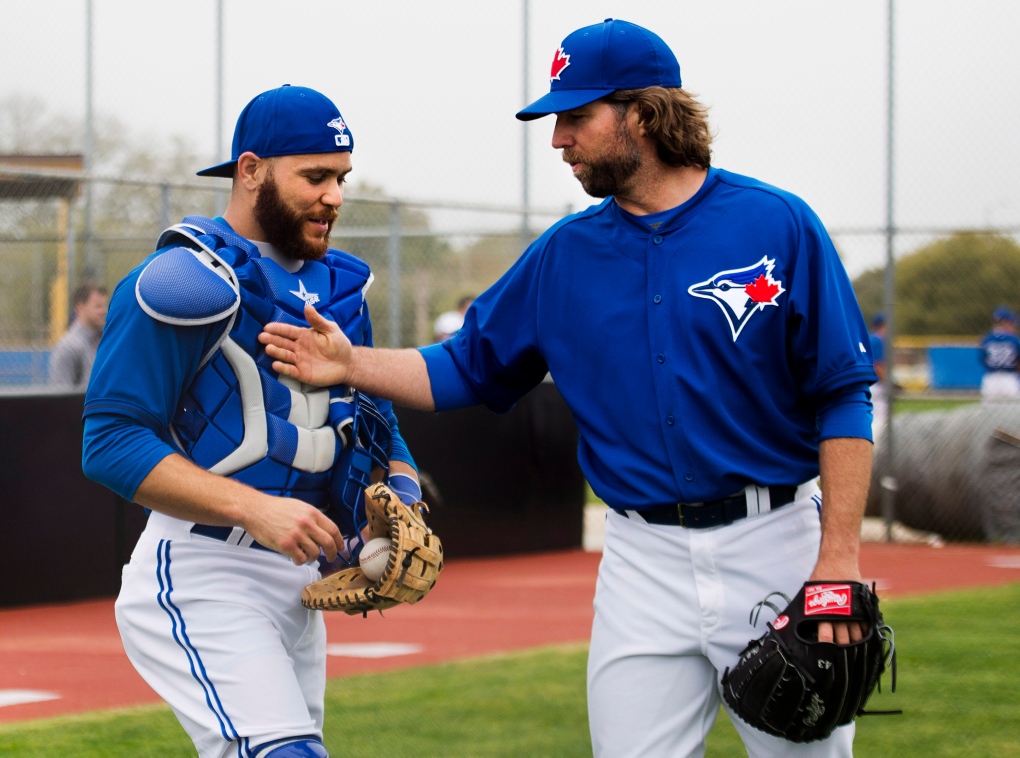 R.A. Dickey talks with Russell Martin at training
