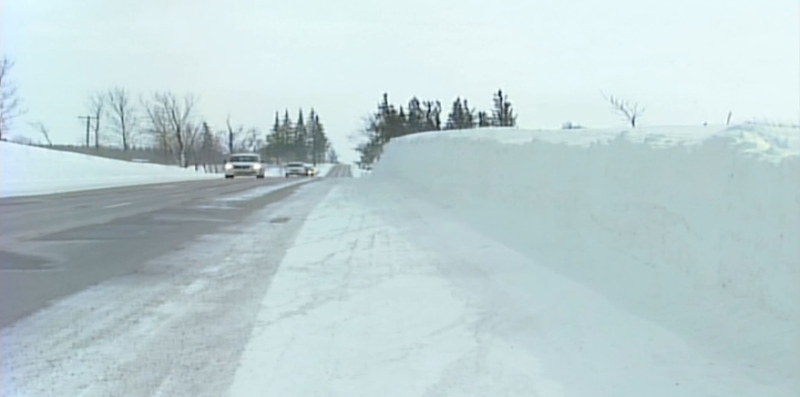 Vehicles are dwarfed by giant snow banks in Bruce County, Ont. on Thursday, Feb. 26, 2015. (Scott Miller / CTV London)