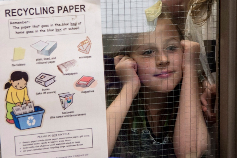 Isabella Schiavone a grade 3 student at Westwood Public School in Guelph, Ontario peers through a glass panel at on Wednesday May 14 , 2014. (Chris Young/THE CANADIAN PRESS)