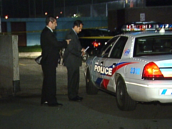 Police investigate at the scene of a shooting on Silverstone Drive in the Finch-Kipling area.
