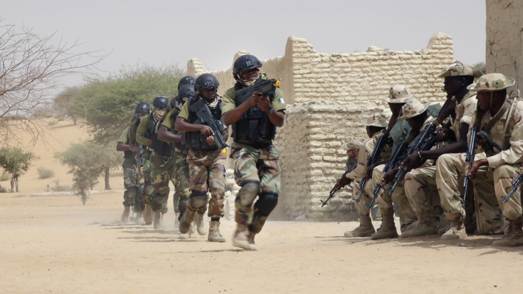 Nigerian special forces run past Chadian troops