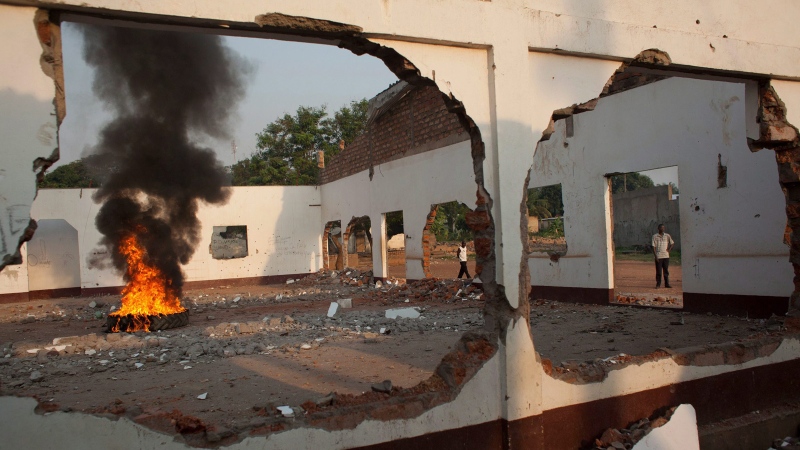 Residents burn a tire in a mosque that was destroyed in sectarian violence in Bangui, Central African Republic, on Monday, Dec. 23, 2013. (AP Photo/Rebecca Blackwell)