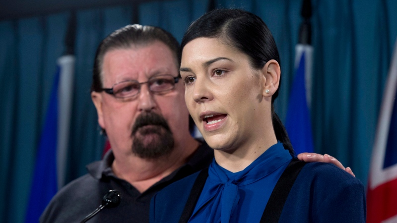 Chris Huck supports his daughter Stephanie Huck as she talks about her son Daniel Ten Oever during a news conference in Ottawa, Wednesday Mar.18, 2015. Huck alleges her-nine-year-old autistic son was handcuffed while at school. (Adrian Wyld/THE CANADIAN PRESS)
