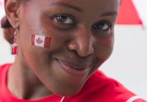 A woman enjoys the festivities during the annual Canada Day parade in Montreal, Tuesday, July 1, 2014. (Graham Hughes / THE CANADIAN PRESS)