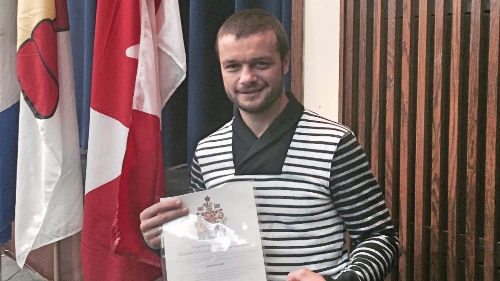 Ionut (Jo Jo) Dan poses with Canadian citizenship 
