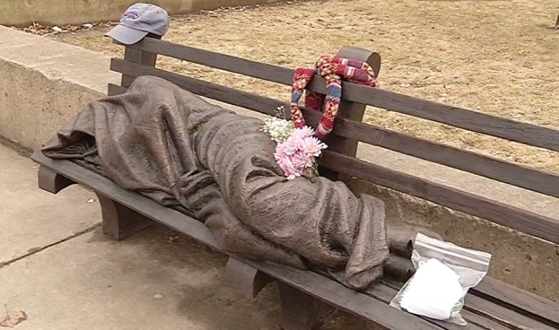 A blanket-shrouded Jesus statue, identifiable only by the crucifixion wounds on his feet, is outside St. Paul's Episcopal Cathedral in Buffalo, NY on April 3, 2015. (AP / Courtesy of WIVB-TV)