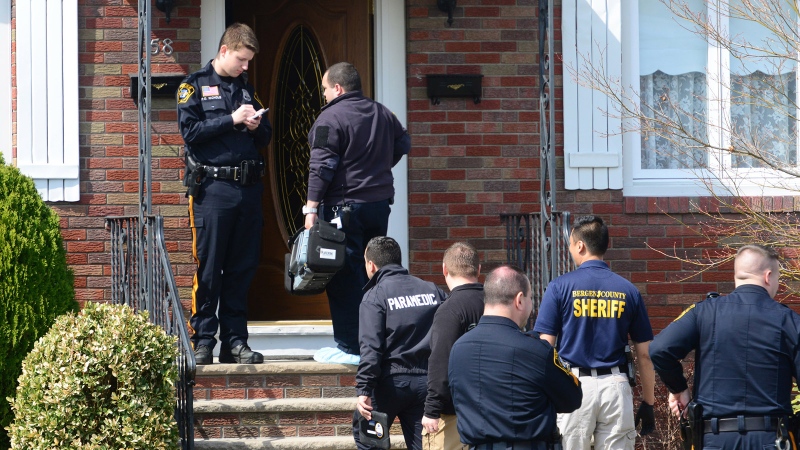 Authorities arrive at a home where the bodies of an elderly couple were found Monday, in Elmwood Park, N.J., April 6, 2015. (Northjersey.com/Tariq Zehawi)