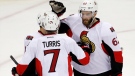 Ottawa Senators players, Kyle Turris (7), Eric Gryba (62) and Clarke MacArthur (16), celebrate a goal by Turris against the New Jersey Devils during the third period of an NHL hockey game, Wednesday, Dec. 17, 2014, in Newark, N.J. The Senators won 2-0. (AP/Julio Cortez)