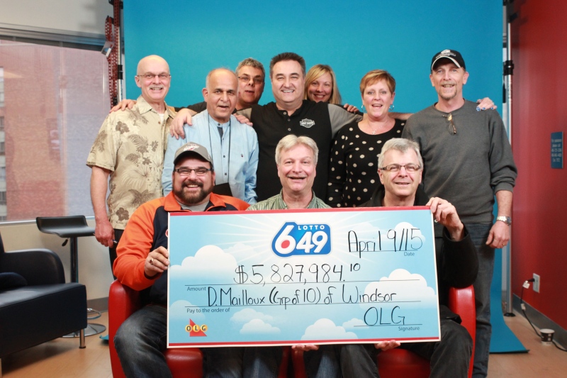 A group of Lotto 6/49 winners who work together at a Windsor hospital pose with their cheque in Toronto, Ont. on Thursday, April 9, 2015. (Courtesy OLG)