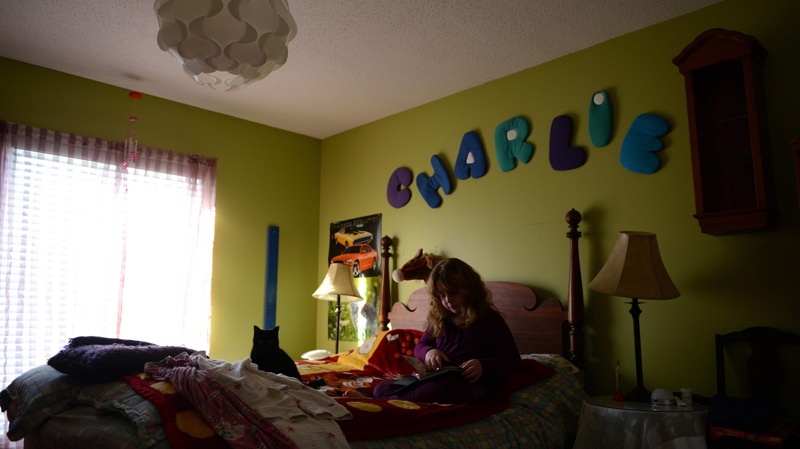 Charlie, age 9, who was born as a male but identifies as a female, is seen in her room at home in Ottawa on Wednesday, March 24, 2015. (Sean Kilpatrick / THE CANADIAN PRESS)