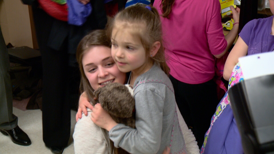 Madeleine hugs big sister Lydia, who performed CPR