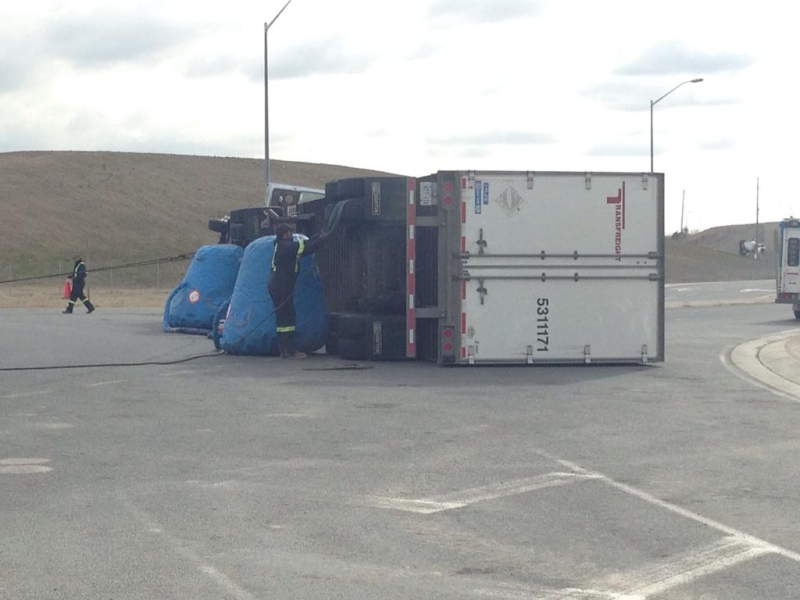 A transport truck was being removed after rolling onto its side on the Highway 3 roundabout in Windsor, Ont., April 22, 2015. (Rich Garton / CTV Windsor)