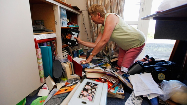 Jean Smith stacks her bookshelves