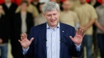Prime Minister Stephen Harper speaks to supporters about a tax cut to small business included in the Economic Action Plan 2015 during a press conference at FC Woodworks Inc. in Winnipeg, Thursday, April 23, 2015. (John Woods / THE CANADIAN PRESS)