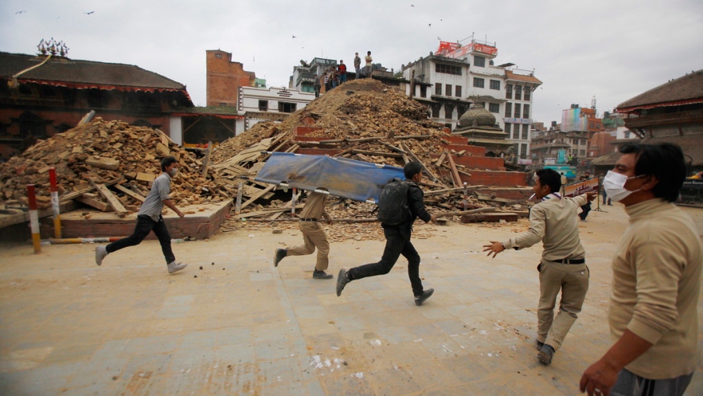 Volunteers run with a stretcher in Kathmandu